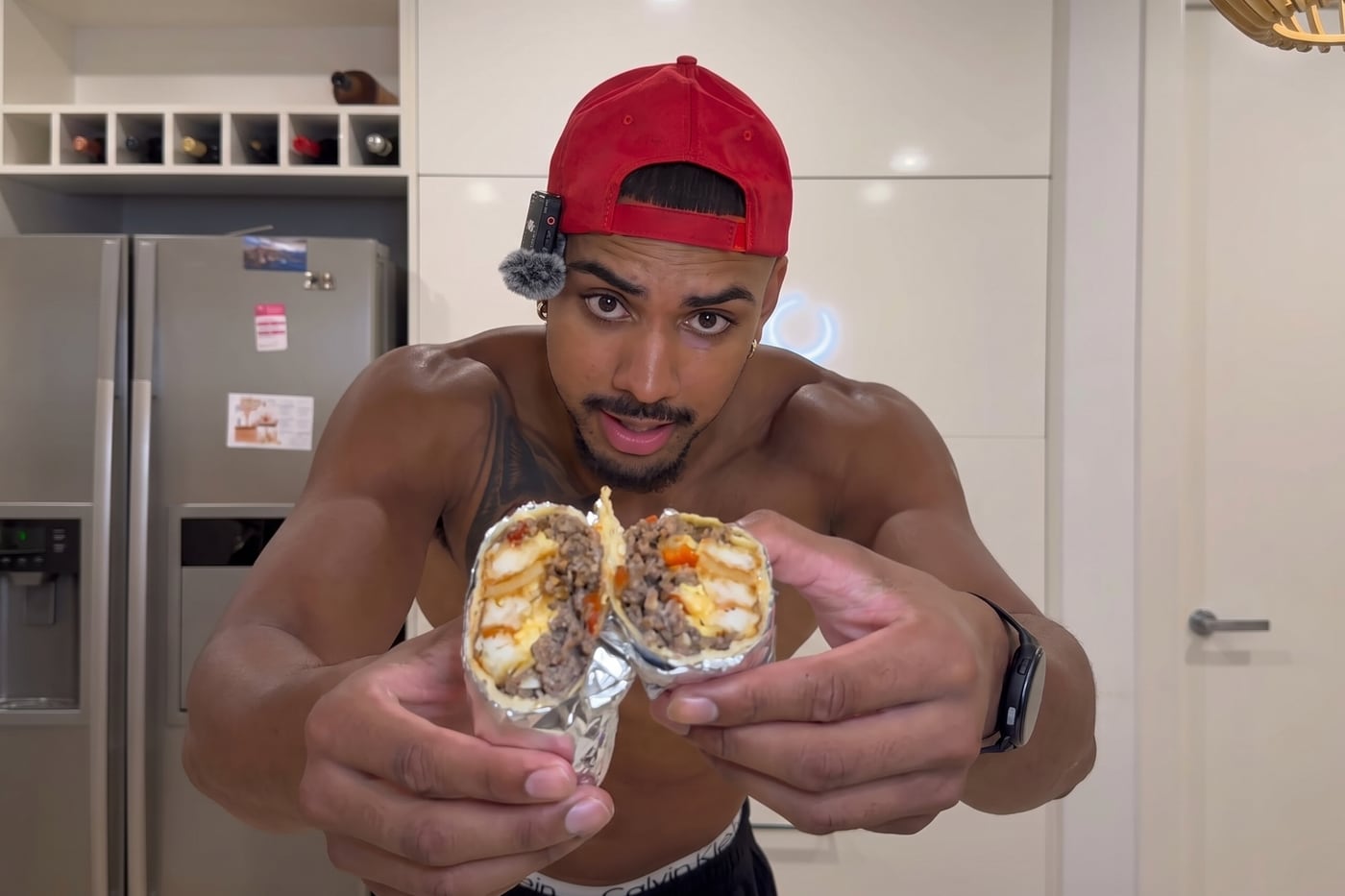 Two halves of a high-protein beef burrito, cut ends to camera, showing beef mince, egg and capsicum